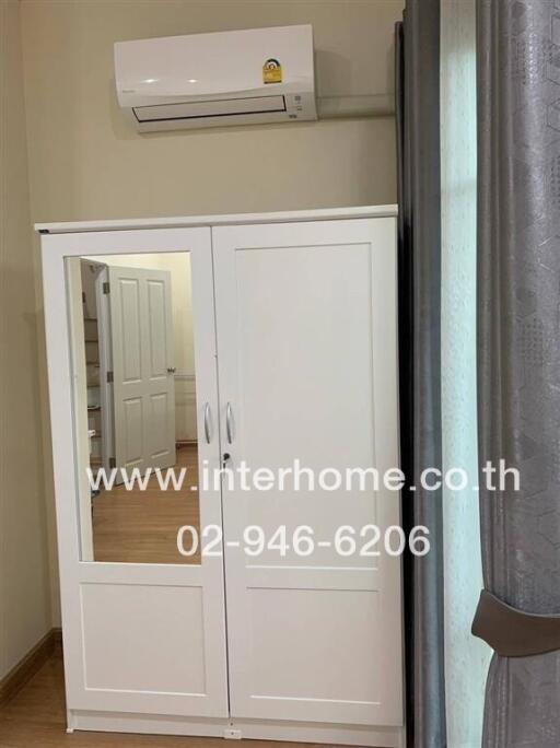 Bedroom with wardrobe and air conditioner