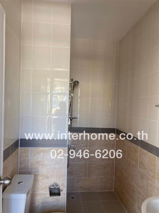 Bathroom with tiled walls and a shower