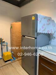 Kitchen with grey refrigerator and water heater