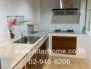 Modern kitchen with stainless steel sink and gas stove