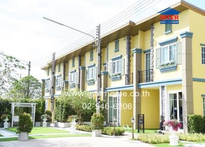 Exterior view of townhouses with gardens and decorated facades