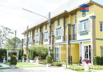 Exterior view of townhouses with gardens and decorated facades