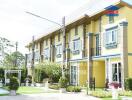 Exterior view of townhouses with gardens and decorated facades