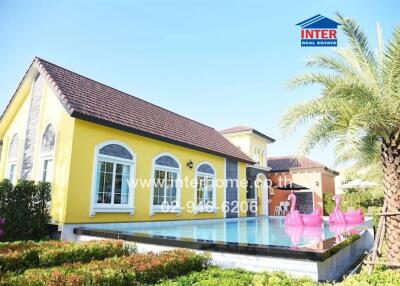 Beautiful yellow modern single-family house with a pool and garden.