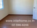 empty bedroom with wooden flooring and a window