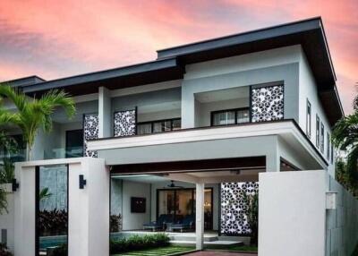 Modern two-story house with driveway and well-maintained garden