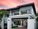 Modern two-story house with driveway and well-maintained garden