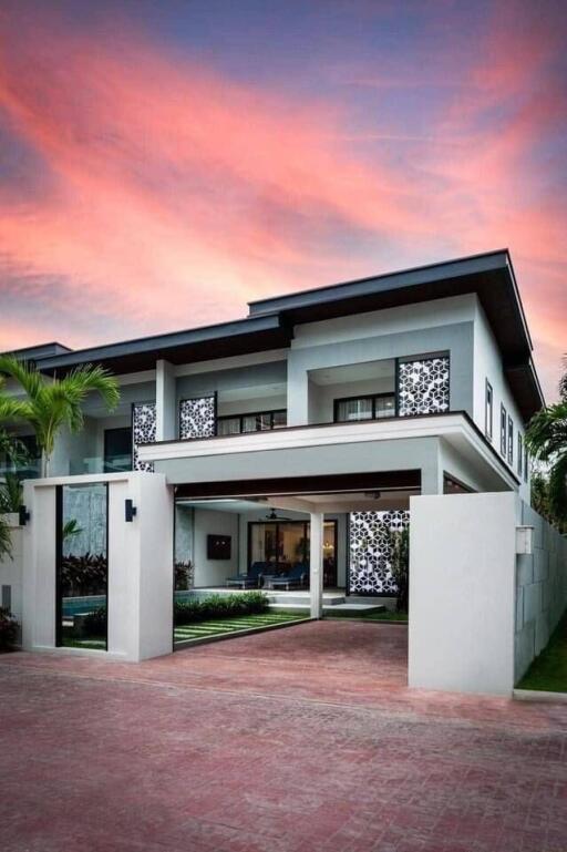 Modern two-story house with driveway and well-maintained garden