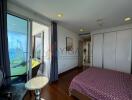 Bedroom with balcony and ocean view