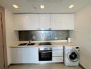 Modern kitchen with white cabinets and built-in appliances