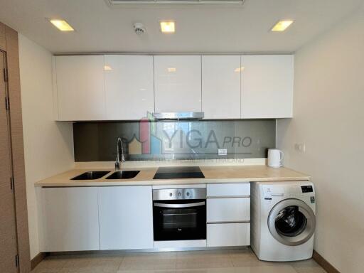 Modern kitchen with white cabinets and built-in appliances