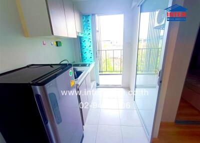 Small kitchen with modern appliances and a balcony