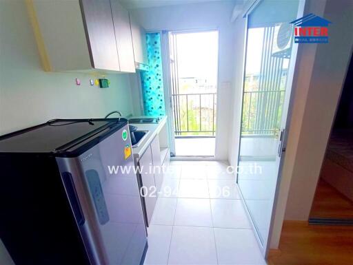 Small kitchen with modern appliances and a balcony