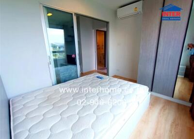 Bedroom with bed, wardrobe, air conditioner, and wooden flooring