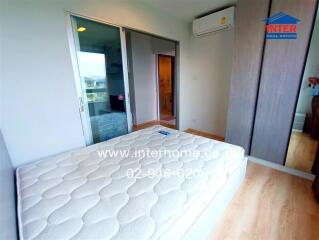 Bedroom with bed, wardrobe, air conditioner, and wooden flooring