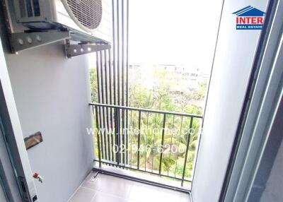 Balcony with an air conditioning unit and view of greenery