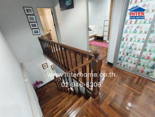 Interior view of a house with wooden stair railing