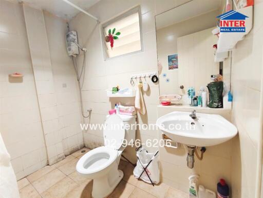 modern bathroom with sink, toilet, mirror, and shower