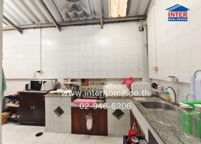 Modern kitchen with appliances and tiled walls