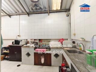 Modern kitchen with appliances and tiled walls