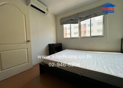 Bedroom with bed, window, and air conditioning unit