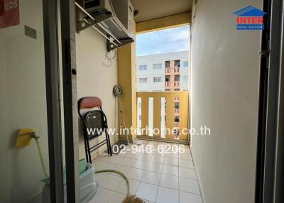 Balcony with hanging air conditioning unit and view of neighboring buildings