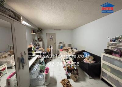 Bedroom with mixed furniture and clutter