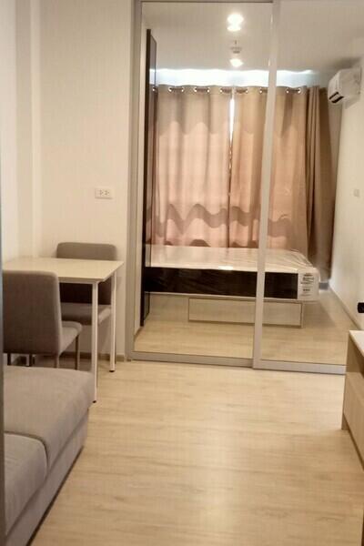 Studio apartment with a view of the bed and dining area