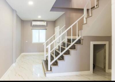 Main living area with staircase and modern decor