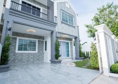 Modern two-story house with stone facade and large windows