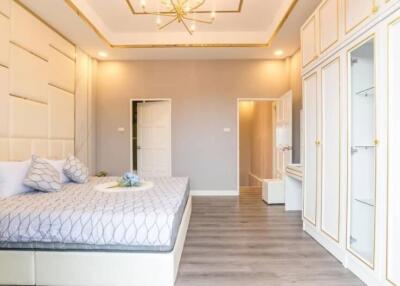 Modern bedroom with bed, built-in wardrobes, and decorative ceiling light