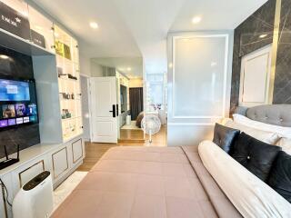 Modern bedroom with open wardrobe and ensuite bathroom