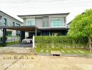 Exterior view of a modern two-story house with a carport and a garden