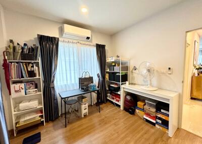 Home office or study area with desk, shelves, and storage space