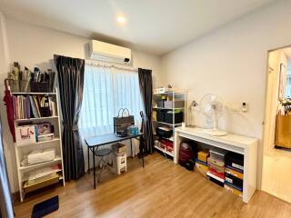 Home office or study area with desk, shelves, and storage space