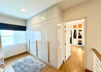 Bright bedroom with built-in wardrobes and access to walk-in closet