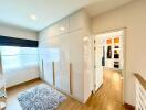 Bright bedroom with built-in wardrobes and access to walk-in closet