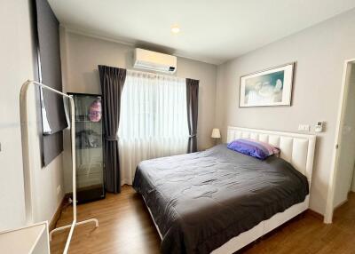 Spacious bedroom with a large bed, air conditioning, and natural light