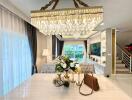 Elegant living area with chandelier and dining table