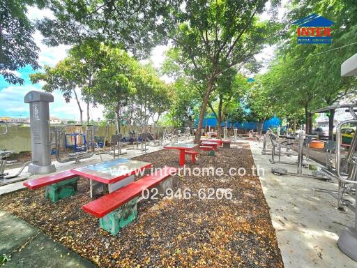 Outdoor fitness area with gym equipment and seating tables