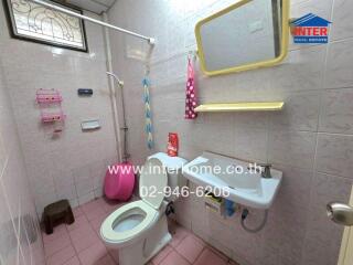 Bathroom with toilet, sink, and shower