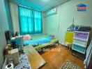 Bedroom with bed, air conditioning, colorful storage unit, and window with green curtains