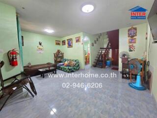 Spacious living room with furniture and staircase