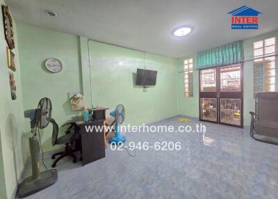 Living room with tiled floor and mint green walls