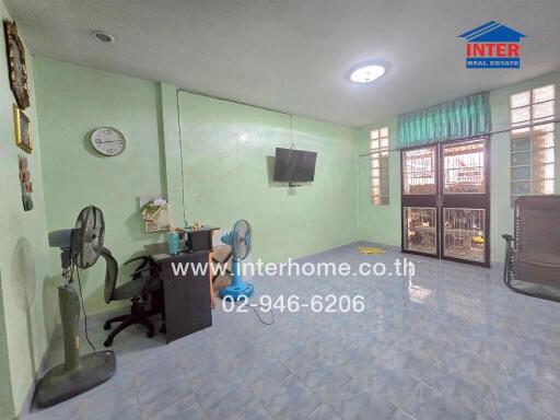 Living room with tiled floor and mint green walls