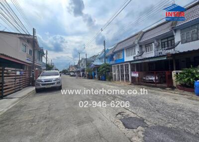 View of a residential street with houses and parked cars