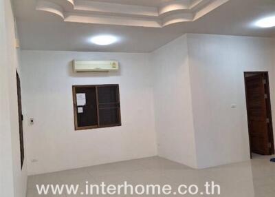 Living room with tiled flooring, recessed lighting, and a wall-mounted air conditioner