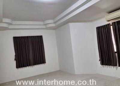 Living room with tiled flooring and dark curtains