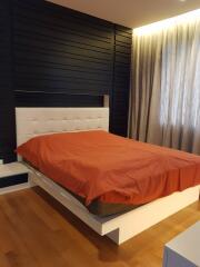 Modern bedroom with wooden floor and stylish headboard