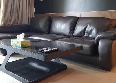 Modern living room with a leather sofa and glass coffee table